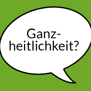 Weiße Sprechblase auf hellgrünem Grund mit Aufschrift "Ganzheitlichkeit"